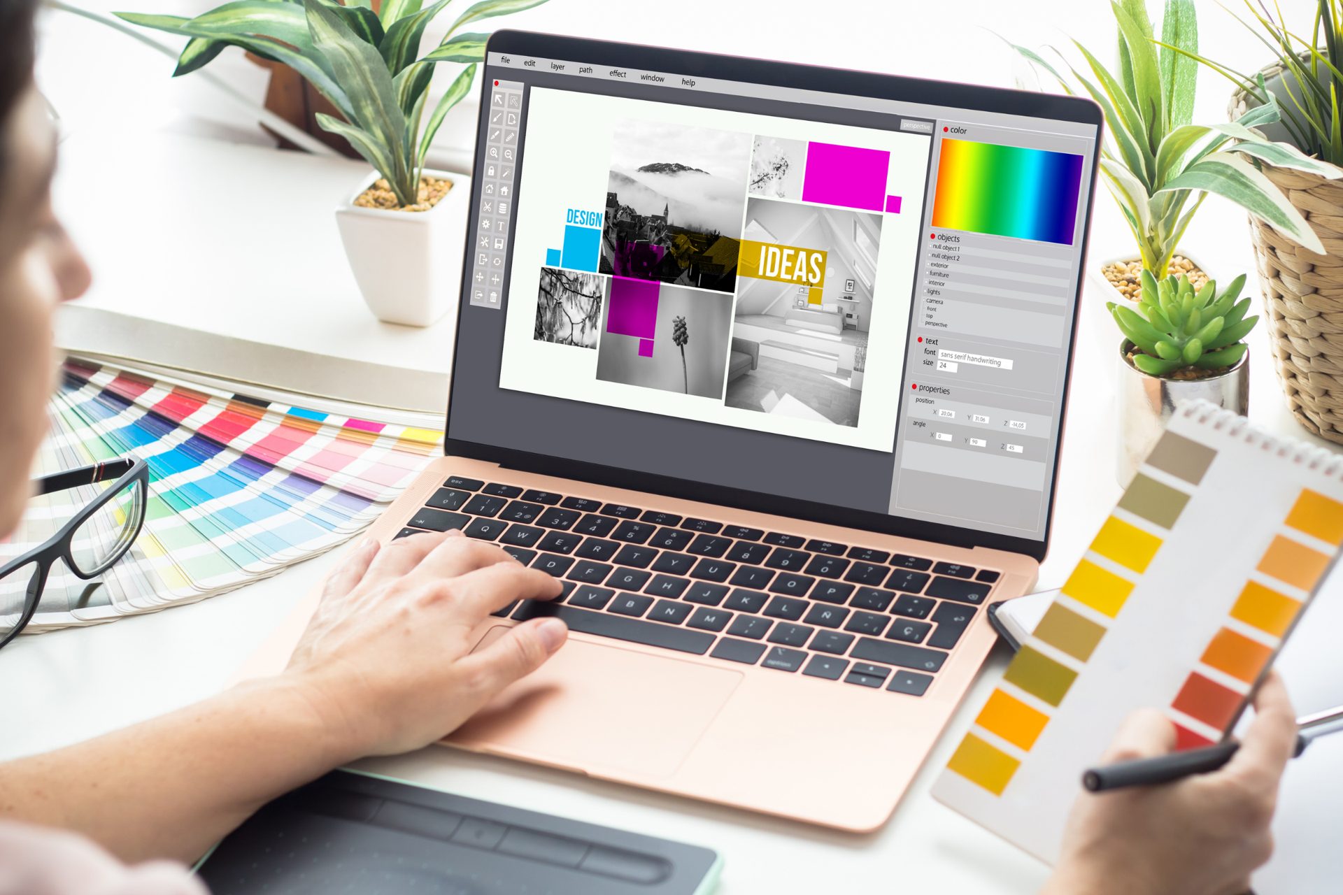 Designer developing brand colors and layouts on a laptop