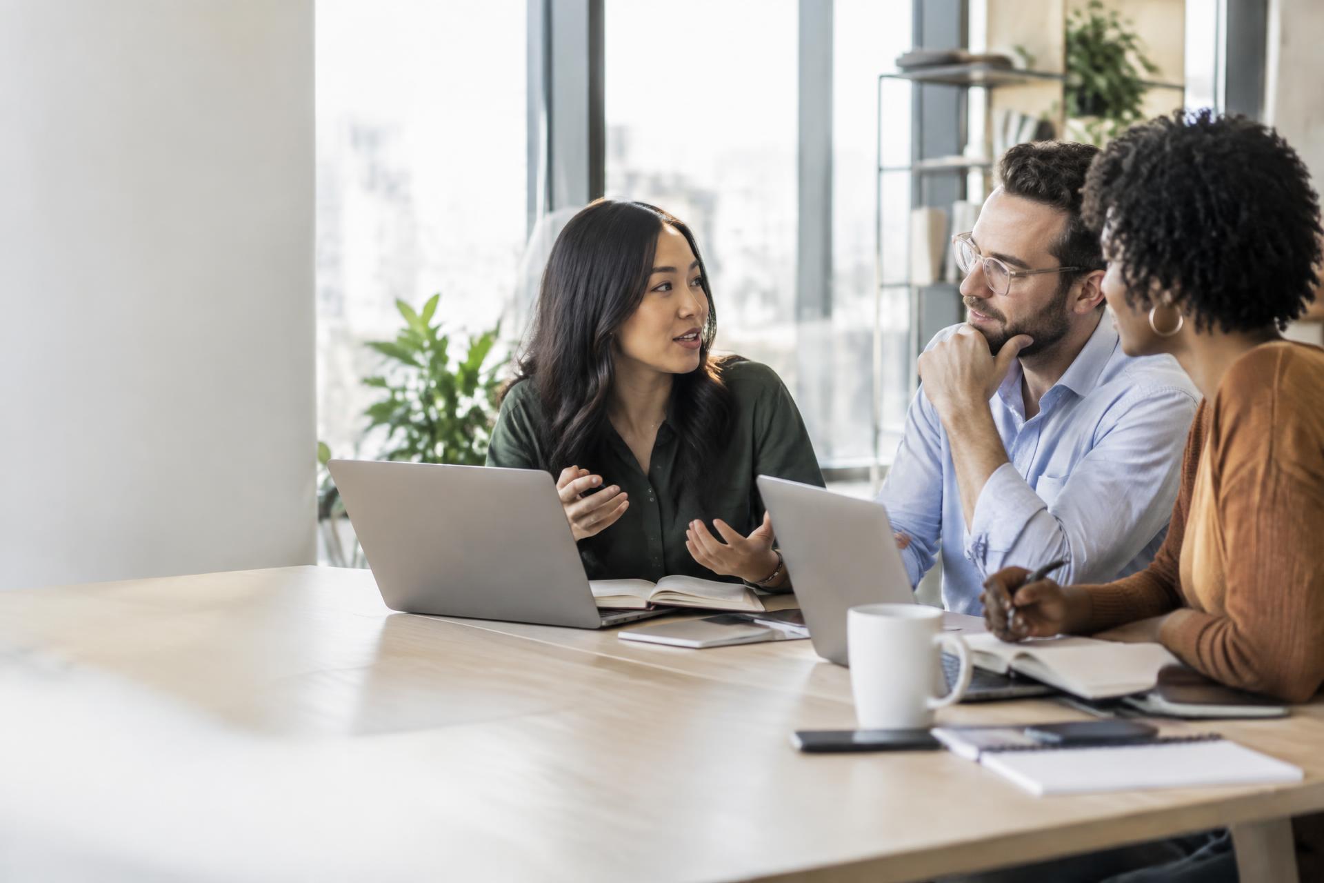 Professionals collaborating around a table in a bright office